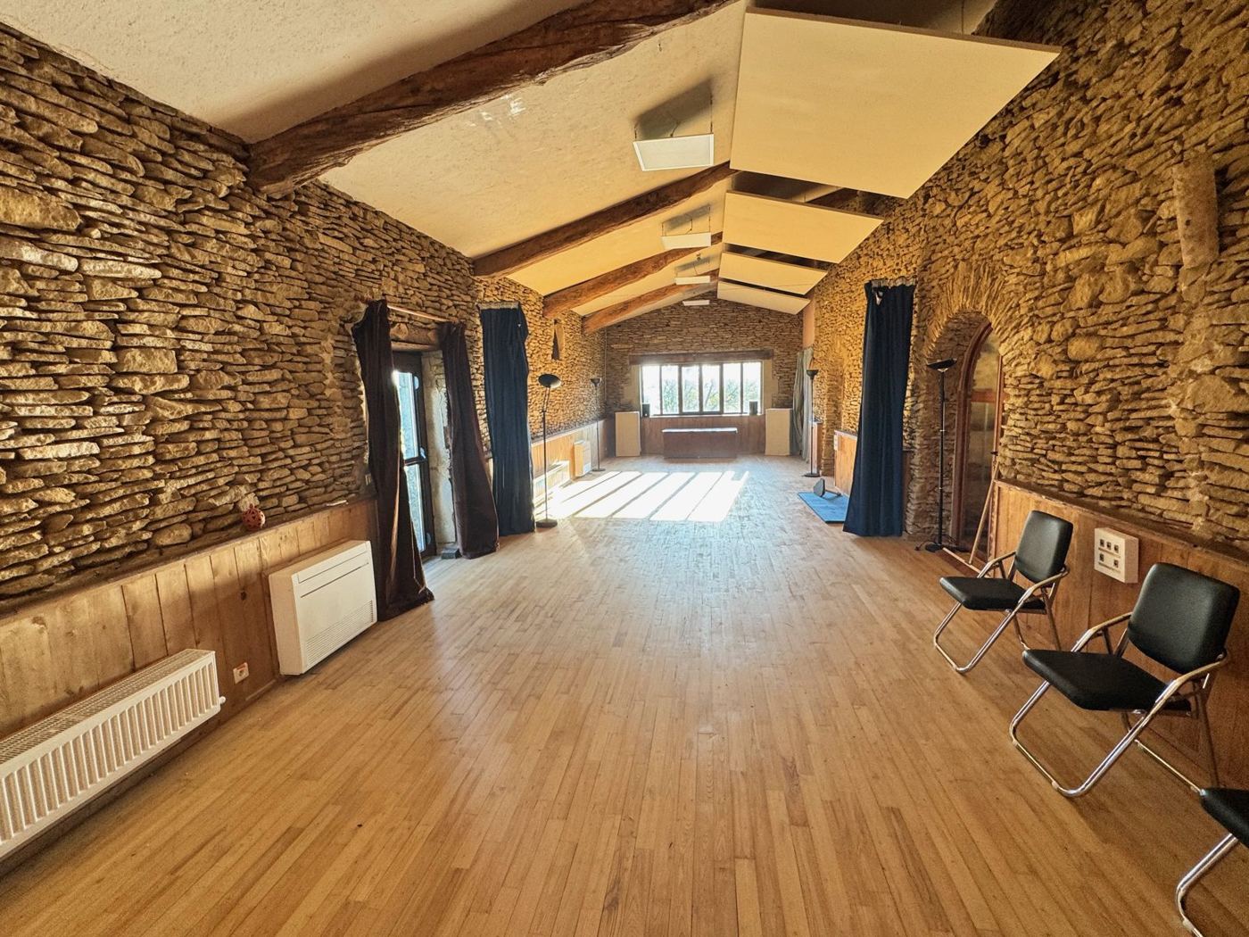 Grande salle de 70 m² en enfilade, murs de pierre et parquet